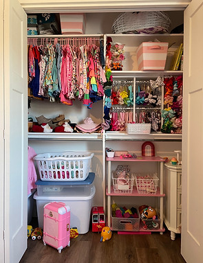 Messy little girl's closet with toys and laundry