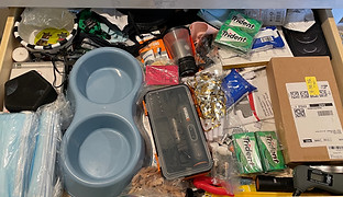 Disorganized messy mudroom junk drawer 