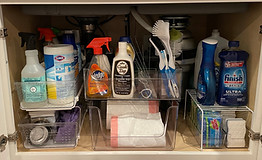 Organized under the sink under the kitchen sink. pull out plastice drawers and clear organizational bins for cleaning supplies, trash bags, dish soap, sponges, scrub brushes