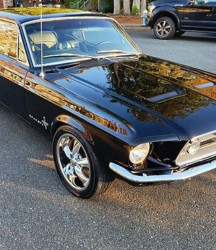 Black classic Ford Mustang with deep, glossy paint after a ceramic coating