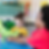 Youth during playtime in front of green dinosaur plush toy