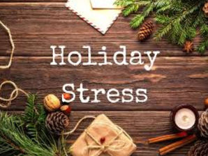 Wooden table with holiday decor: pine branches, pinecones, gift, candle. Text "Holiday Stress" in center. Warm, rustic atmosphere.