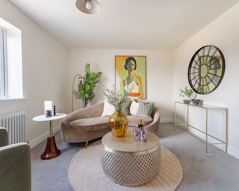 Elegant beige living room with curved sofa, portrait art, large wall clock mirror, plants, and a round coffee table.
