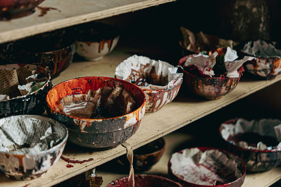Bowls of lacquer paint on a shelf