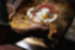 Artisan spraying grounded gold leaves on the lacquer painting of the four hands Avalokiteshvara in Tibetan style