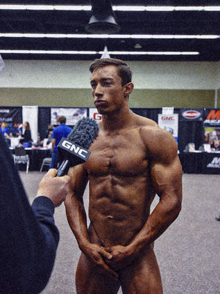 The Uncovered Athlete. Where discipline is laid bare. A photographic series by Stefan Pinto, made backstage at bodybuilding competitions in the hours before performance. In this preparatory space, nudity is practical and unremarked, bodies are oiled, spray-tanned, rested, and adjusted as part of the work of competition. The photographs document a culture in which exposure is embraced as the outcome of discipline and display, presenting the body with confidence, familiarity, and without shame.