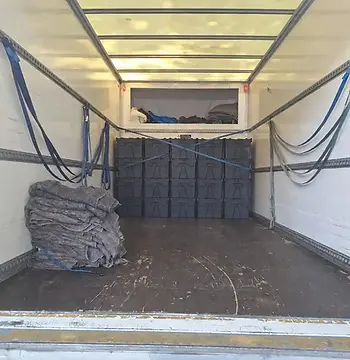Reusable moving crates secured inside a clean Luton removal van