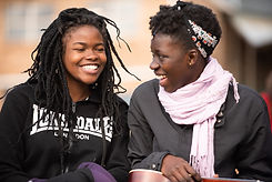 Two African girls laughing and hanging out