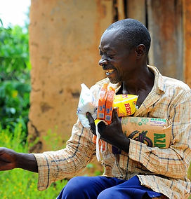 grateful man big smile received in Christmas hamper Uganda