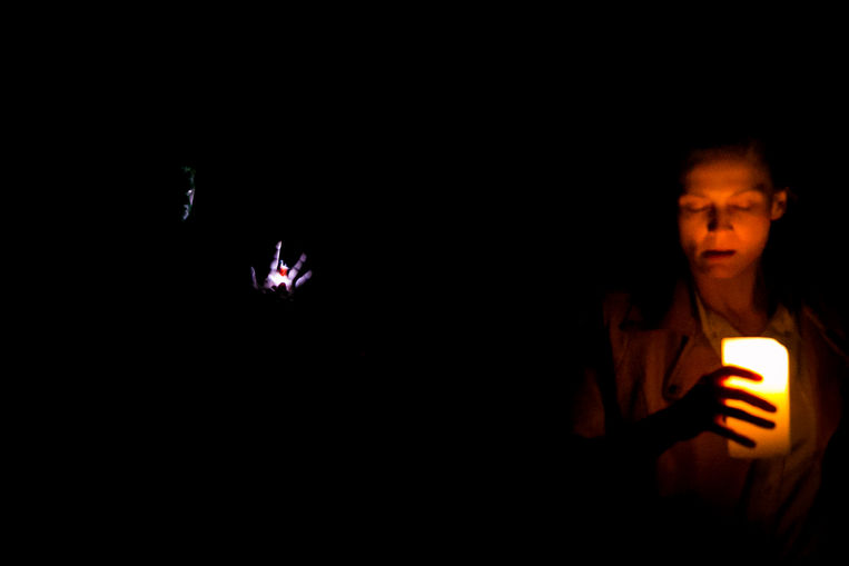 The picture is nearly completely dark, except for a lit candle held by De Flores and one other small spot of light that reveal's Alonzo's missing finger.