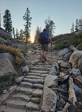Solo hiker going up rock stairs