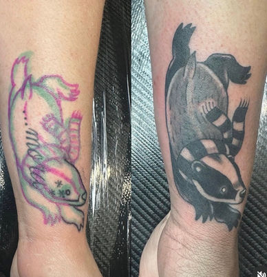 Cover-up tattoo in Layton, Utah — an old colour piece covered with a black and grey raccoon and badger
