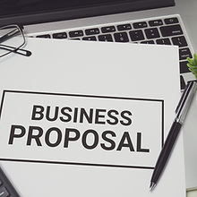 Business Proposal on white paper placed on top of laptop computer. Business concept..jpg