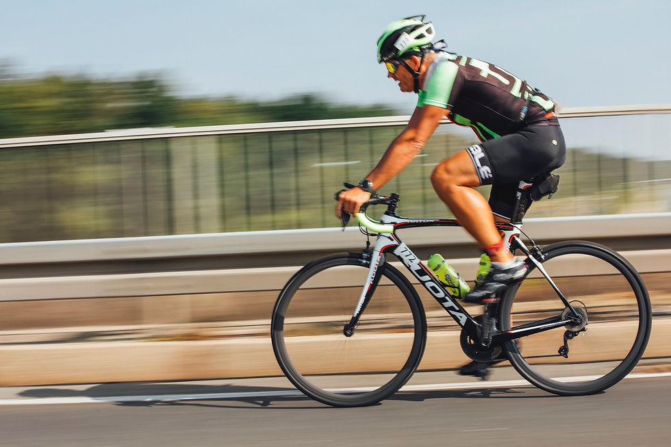 Mature powerful male triathlete on bike