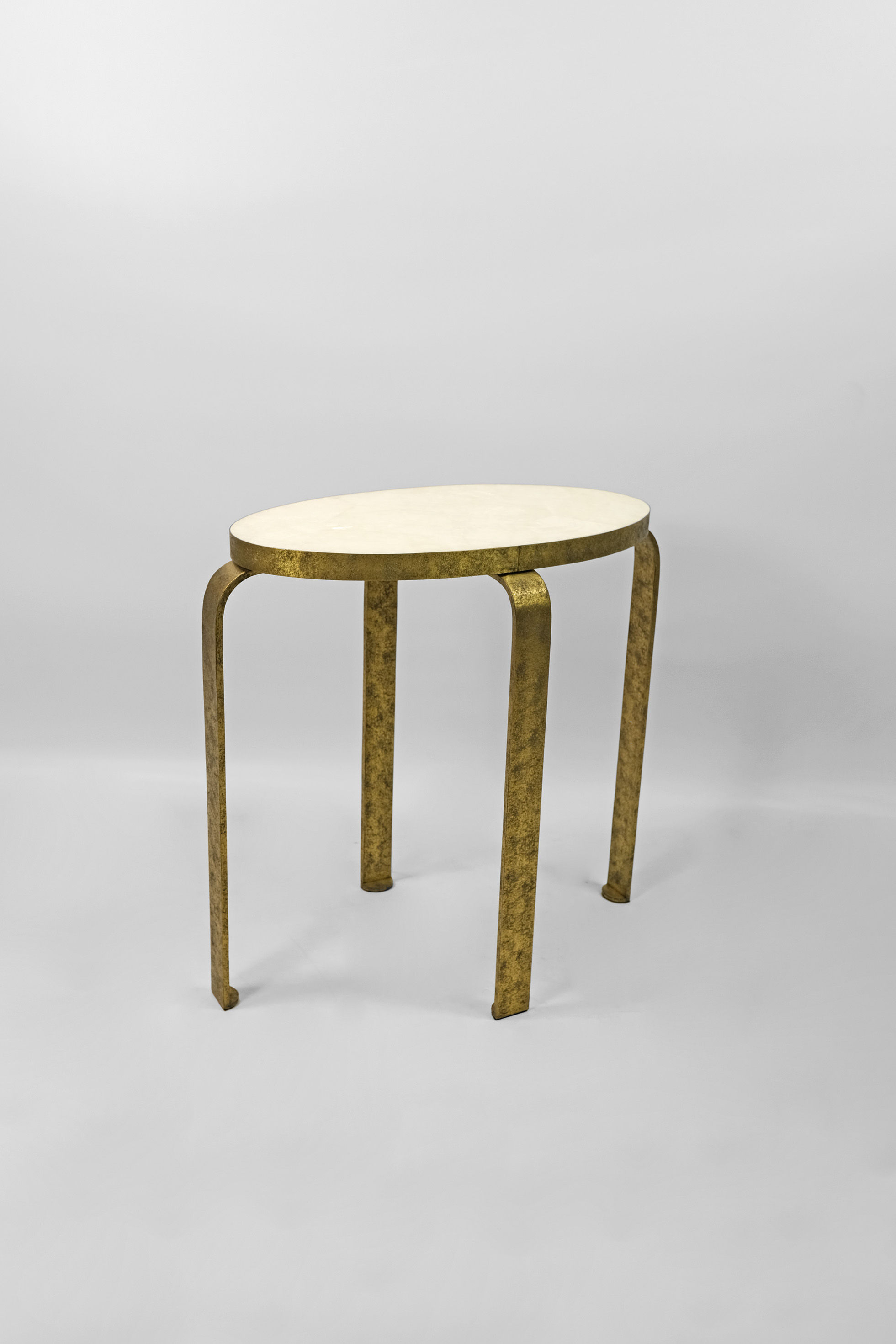 rock crystal side table with textured brass legs by ginger brown