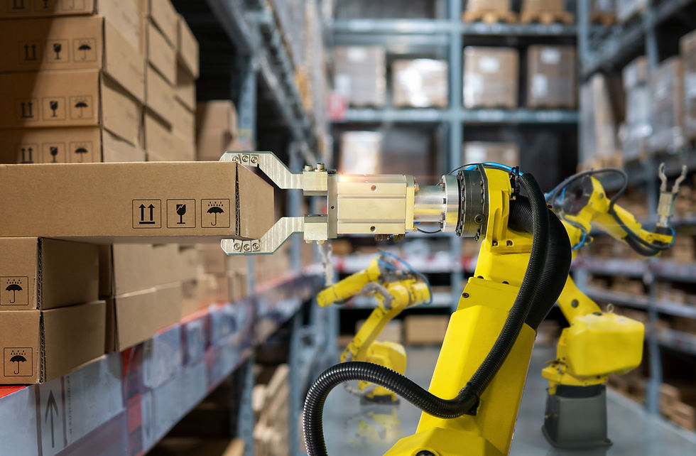 Yellow robotic arm handling a cardboard box in a warehouse, surrounded by shelves and stacked boxes, featuring symbols for handling.