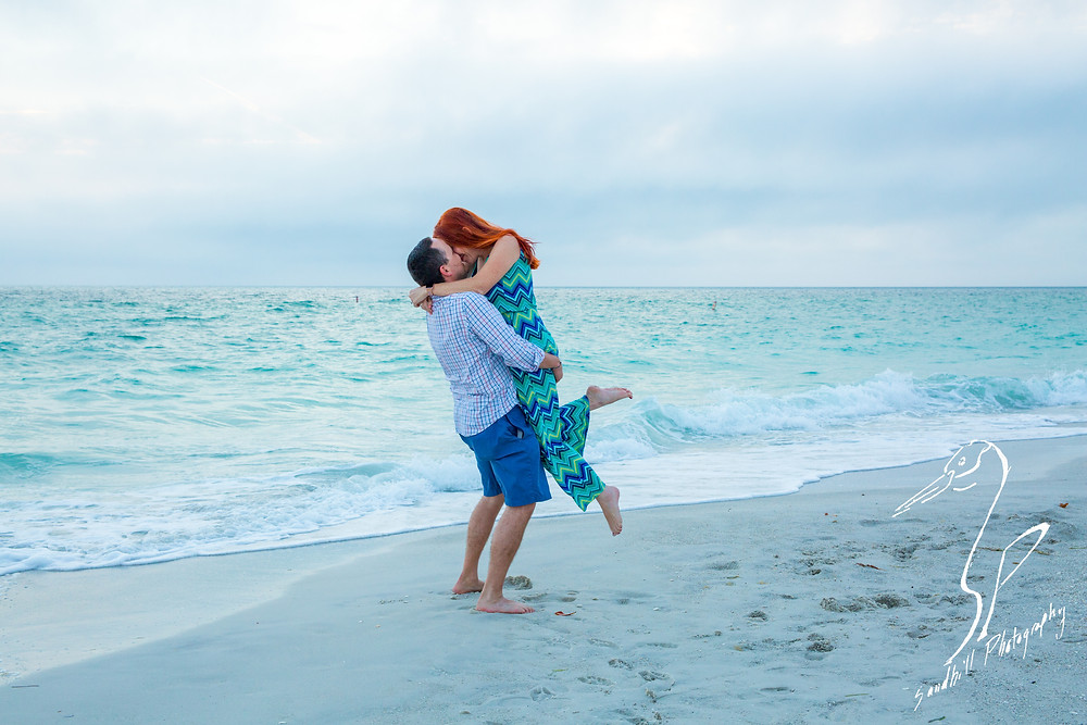 Anna Maria Island Engagement Session Holmes Beach Sunset flash Photography Engagement sand ocean jump lift kiss chevron dress