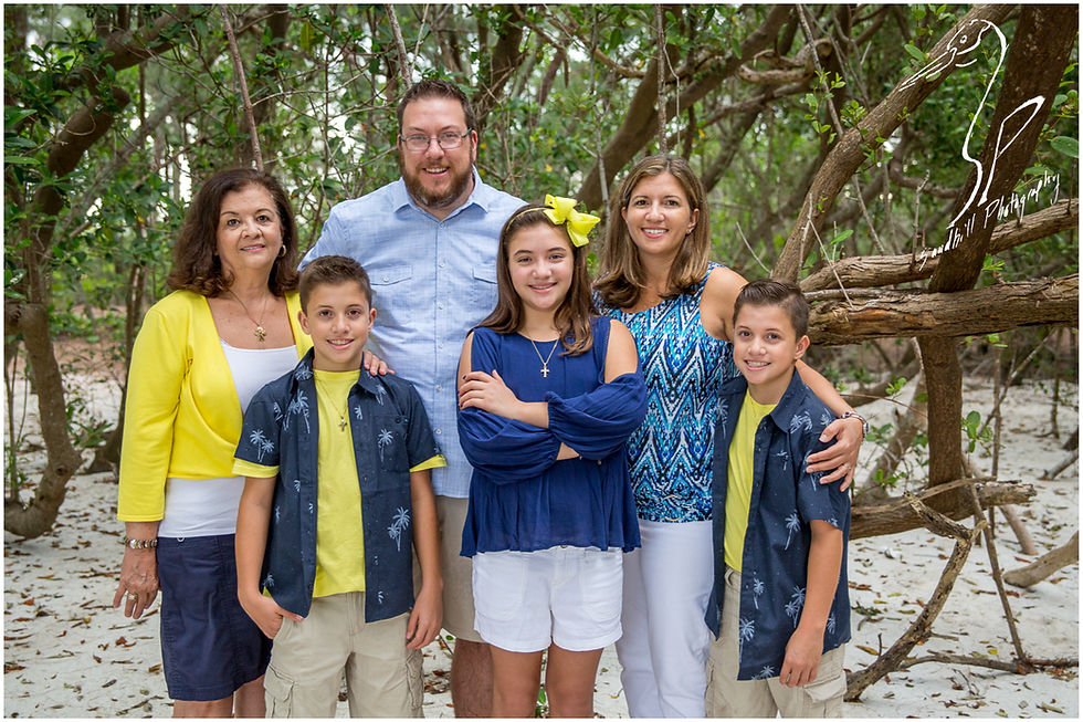 Longboat Key Family Photographer, the entire family stops to pose for a picture in the woods at the beach