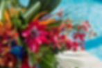 Sarasota Wedding Photographer, poolside reception detail picture of wedding rings and tropical wedding bouquet