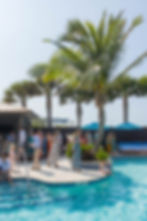 Sarasota Wedding Photographer, poolside reception guests mingle beside the pool