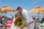 Sarasota Wedding Photographer groom kisses his bride as they leave their wedding ceremony