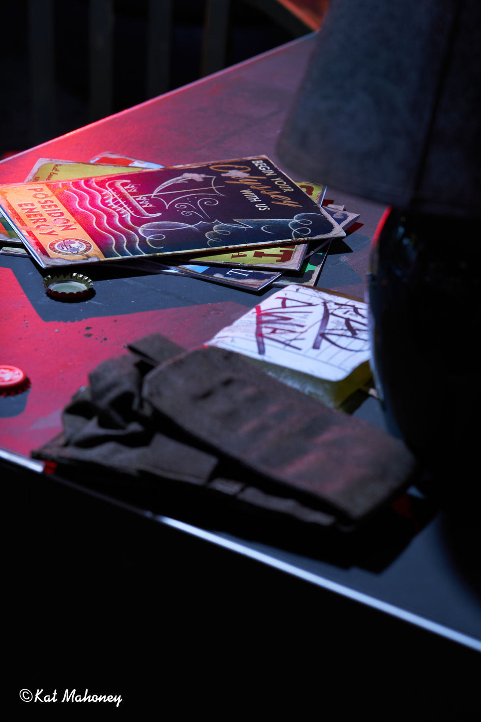 Magazines and gloves on a reflective surface.