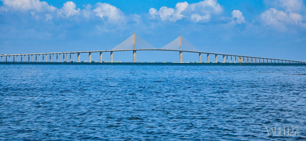 Bridge over water with blue sky background.