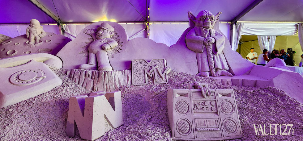 Sand sculptures of cartoon characters and a boombox.