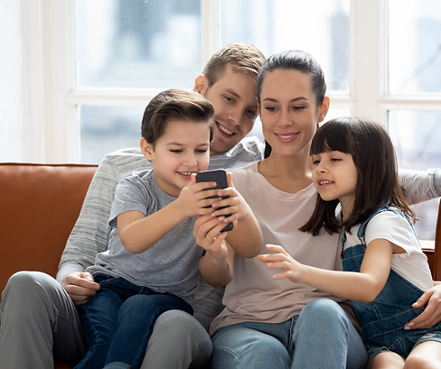 Smiling Family Looking at their Out From Under Debt App.png
