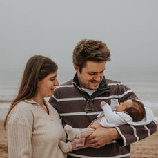 Devon family photography tender moment with couple and newborn baby