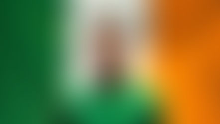 a Celtic player in front of an Irish flag