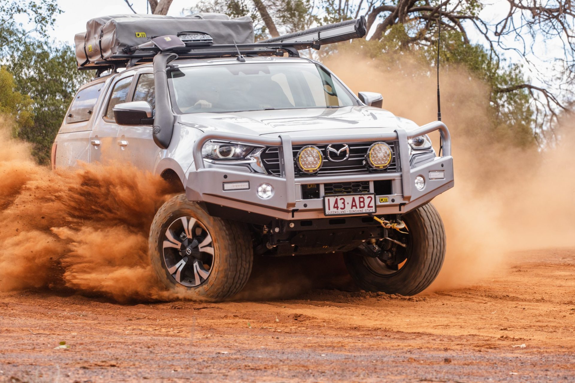 A fully equipped 4WD travelling on a dusty Australian track