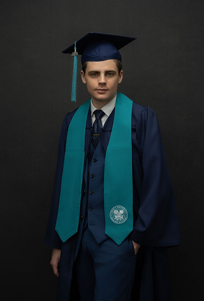 High school senior graduation portrait boy navy cap gown teal stole dark background Melody Smith Portrait Studio Petersburg VA serving Richmond Virginia