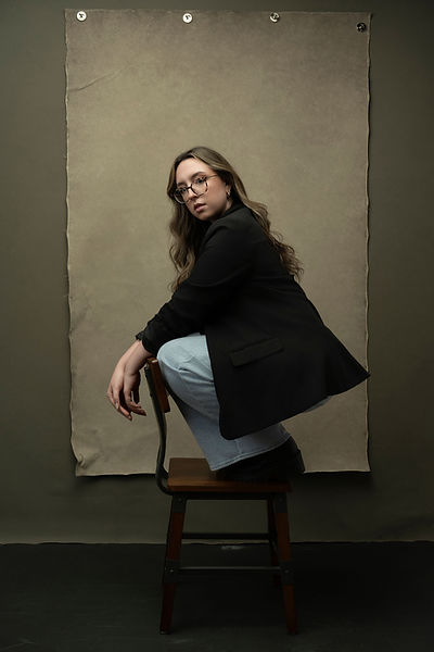 Editorial women's portrait black oversized blazer jeans seated wooden chair canvas backdrop Melody Smith Portrait Studio Petersburg VA serving Richmond Virginia