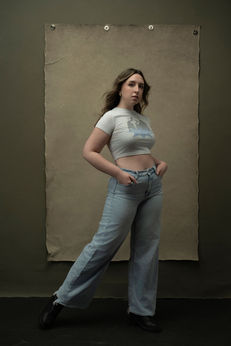 Natural high school senior portrait girl grey top jeans olive background Melody Smith Portrait Studio Petersburg VA serving Richmond