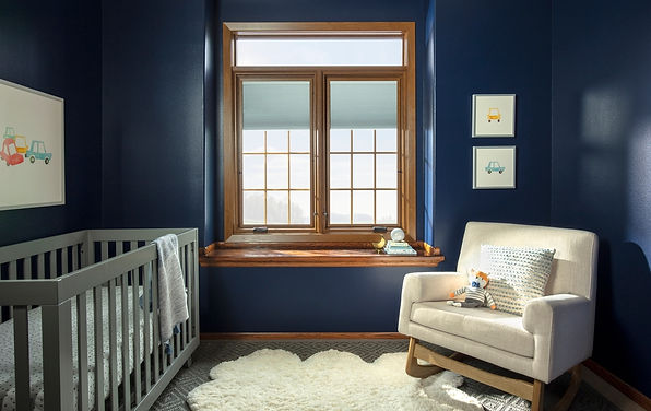 Pella window over a navy, grey and white accented room - image by Pella