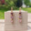 Thumbnail: Golden Dangle Earrings - Pink & Purple Drop Hearts
