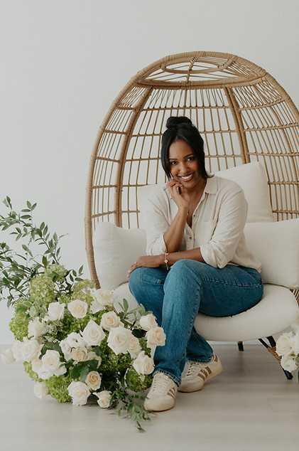 Shawna in studio with lush centerpiece she created.