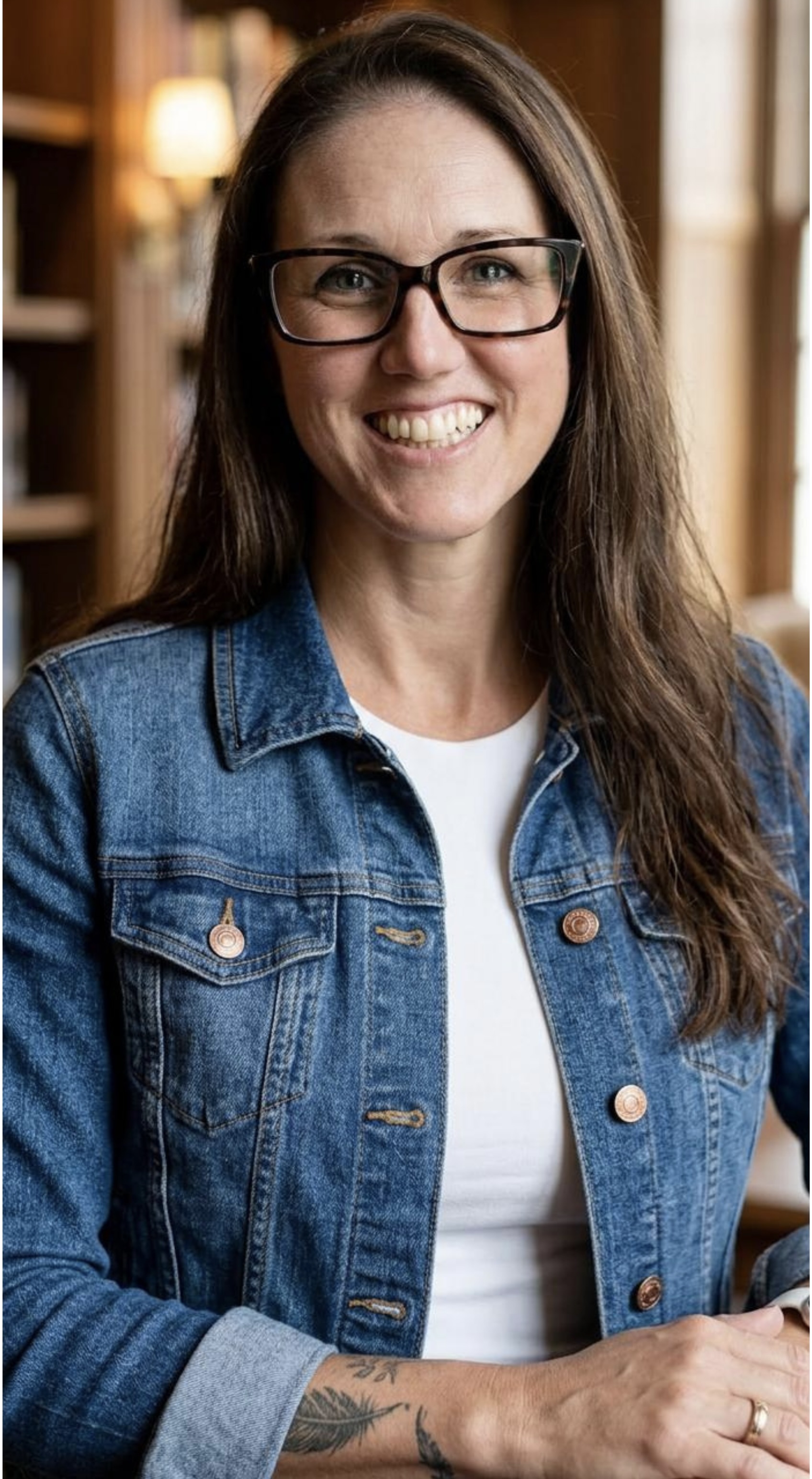 An author photo headshot featuring JL Calder wearing a denim jacket and glasses