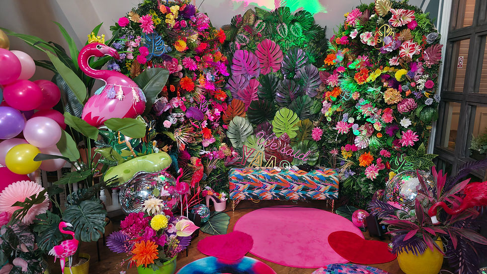 A Jungle inspired backdrop with disco balls and flamingos and lots of colour