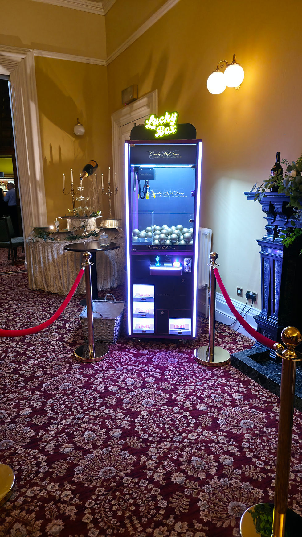 Find a Key Claw Machine wedding entertainment setup with red carpet and VIP ropes