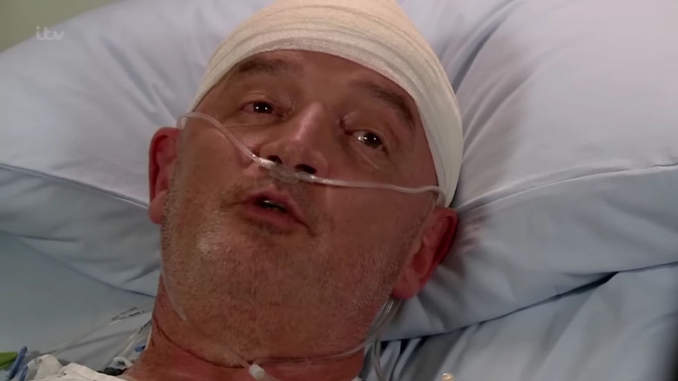 Pat Phelan in hospital with a bandage around his head