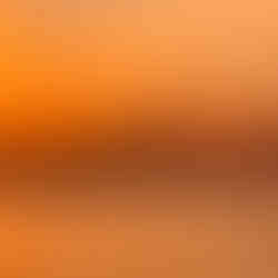 Sunset boat party at Sonus Festival, with people dancing on the deck while the sun sets over the Adriatic Sea, casting pink reflections on the water.