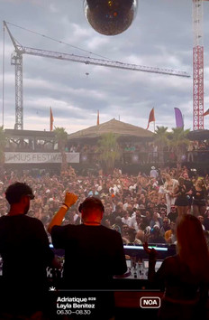 DJ playing an energetic house set at Sonus Festival, with the audience cheering and hands in the air.