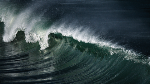 Very clean surf photographed in a dramatic fashion from an elevated angle.