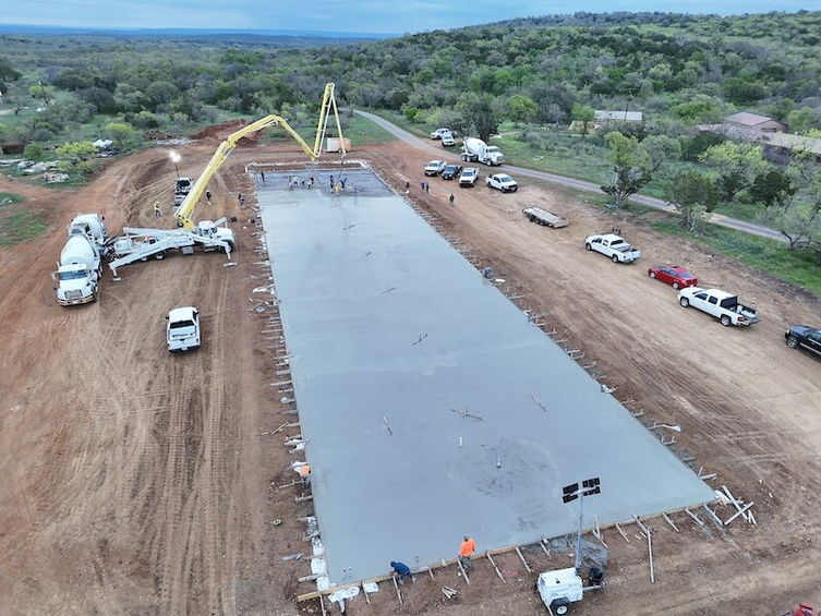 a large concrete foundation being poured