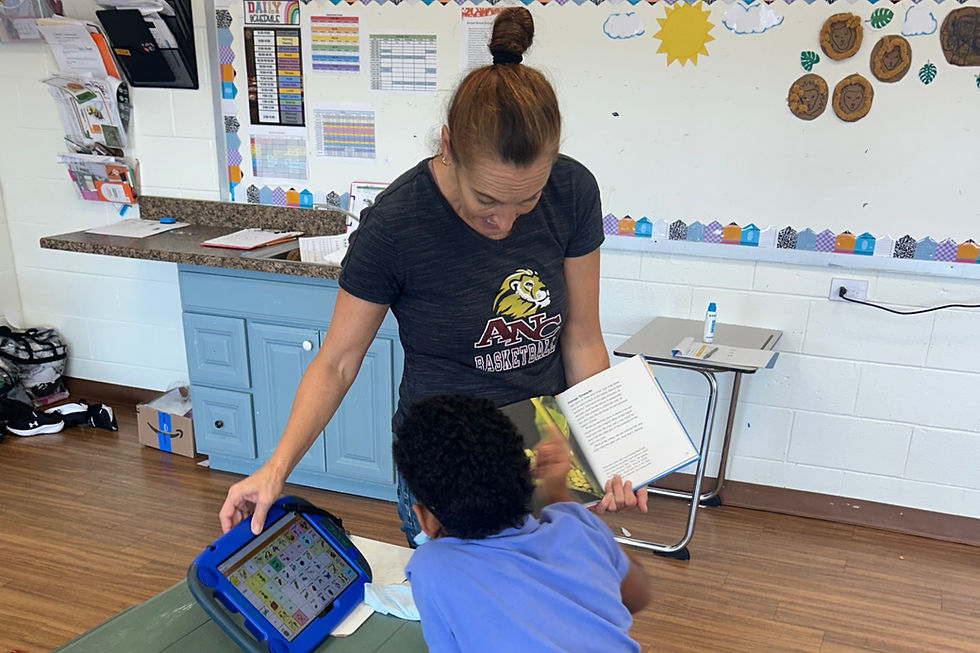 Ms. Michelle reading with a student