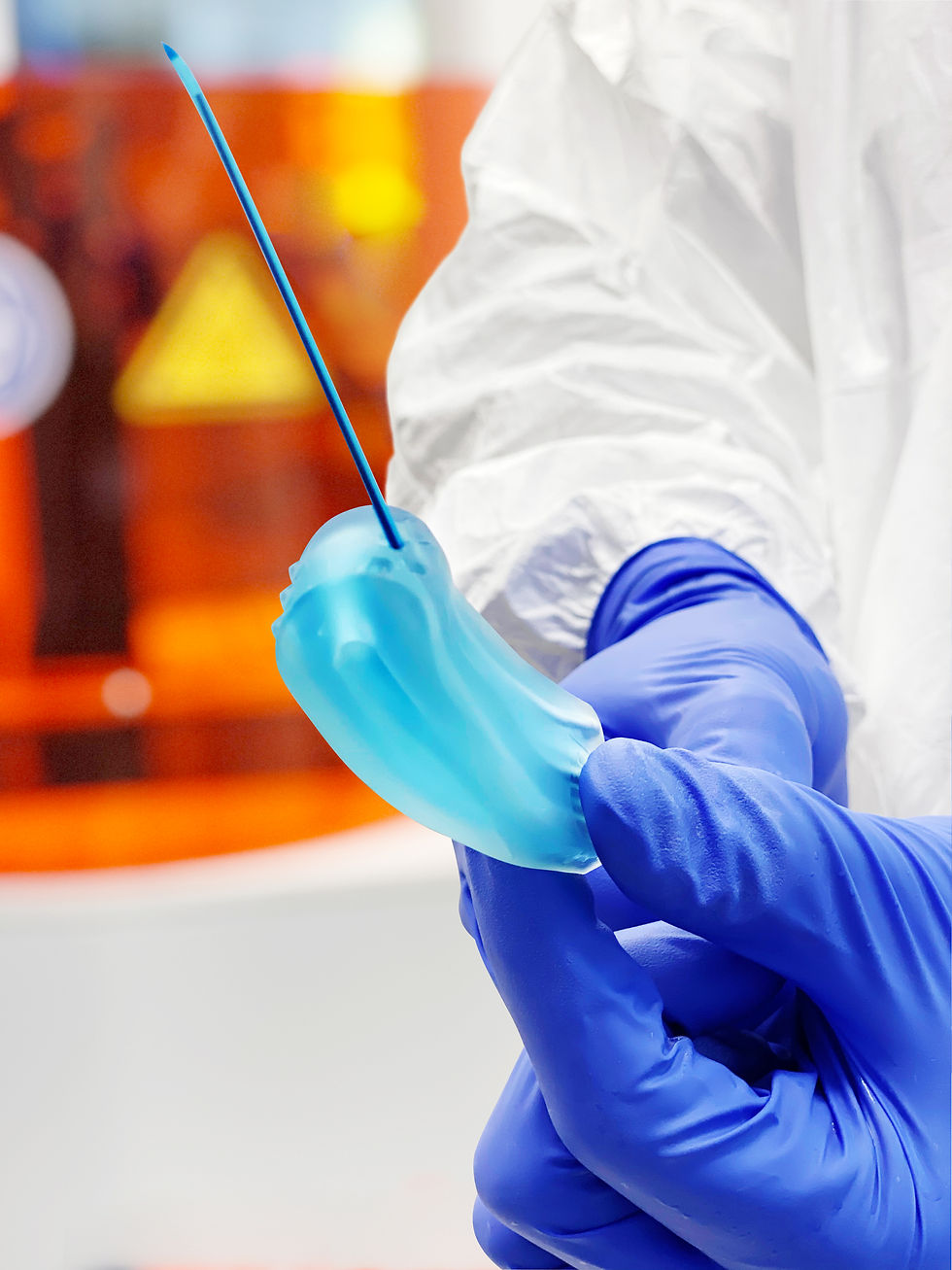 close-up of blue 3d printed component in hands with blue gloves