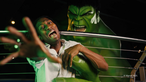 Person dramatically posing in front of a life-sized Hulk figure at Madame Tussauds.
