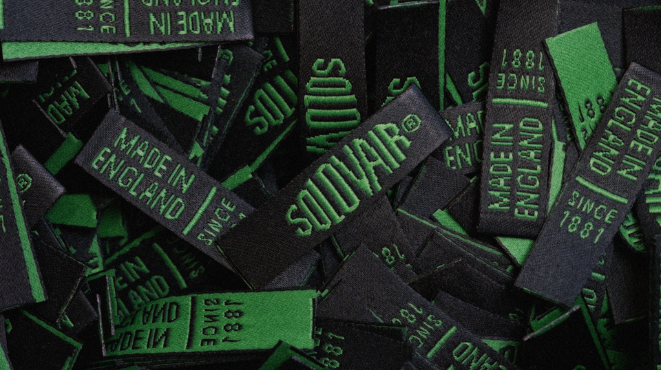 Close-up of multiple Solovair boot labels arranged for stitching.